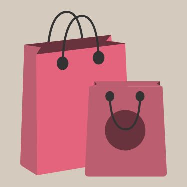 Two pink shopping bags with black handles on a beige background